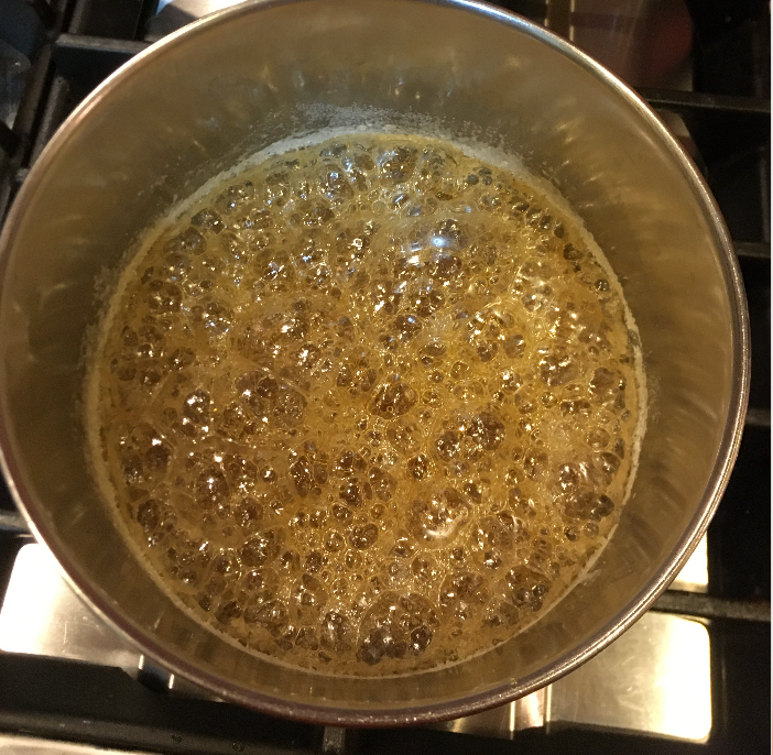 Liquified sugar brought to a boil and allowed to bubble until it reaches 350 F and turns a dark amber color, NO STIRRING!